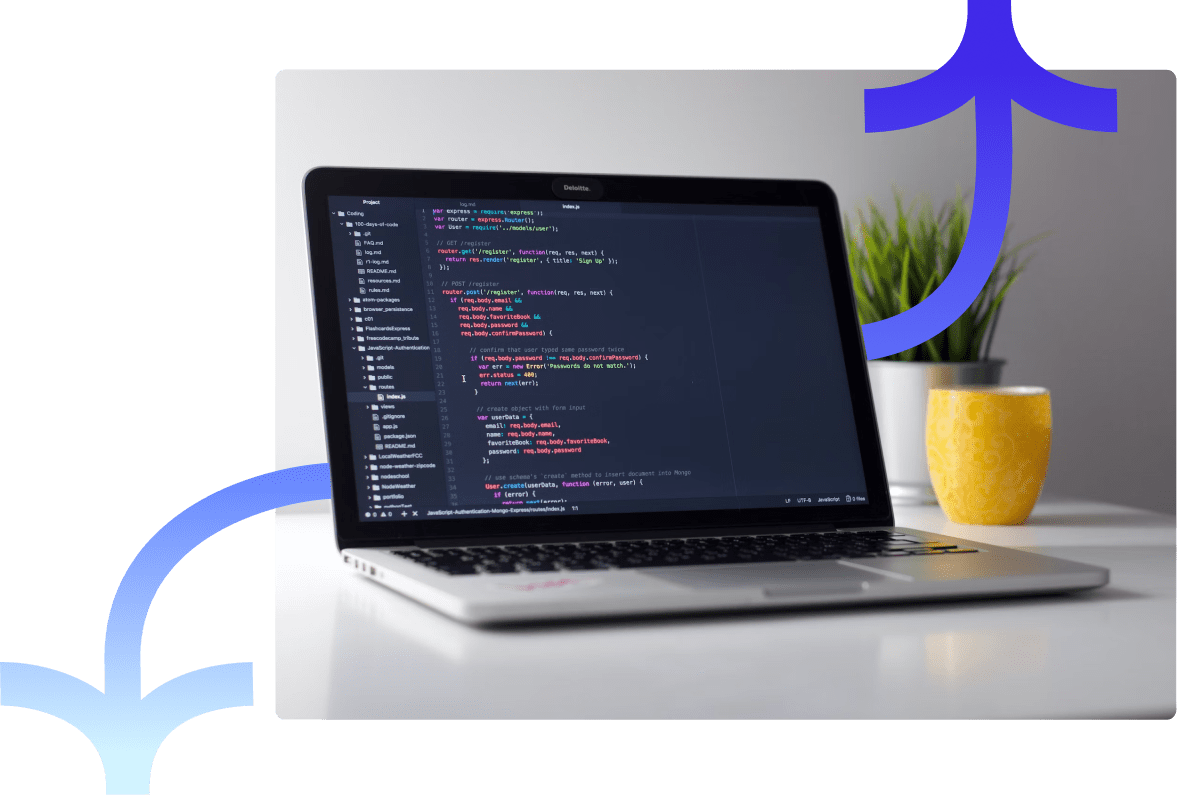 Laptop displaying code with plant